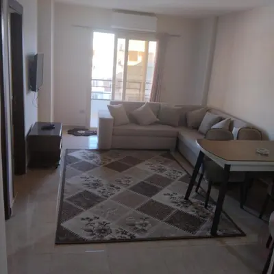 a living room with a couch and a table at Golden Tayeb Hurghada Compound in Hurghada
