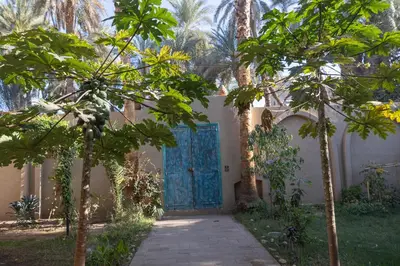 a gate to a house with a blue door at Laziza in Luxor