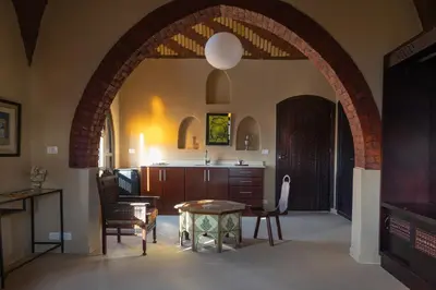 an archway in a kitchen with a table and chairs at Laziza in Luxor