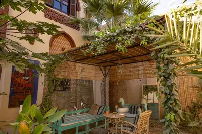 an outdoor patio with a table and chairs at Laziza in Luxor