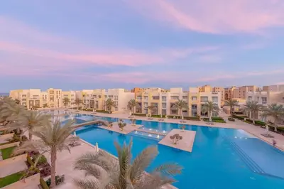an aerial view of a resort with a large pool at Coastal Vibe 2BR Mangroovy Gouna with Rooftop Cinema, BBQ, Pool & Beach Access in Hurghada