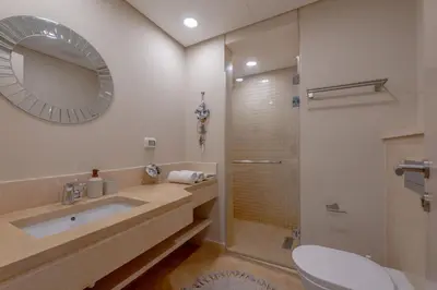 a bathroom with a toilet and a sink and a shower at Coastal Vibe 2BR Mangroovy Gouna with Rooftop Cinema, BBQ, Pool & Beach Access in Hurghada
