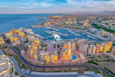 an aerial view of a city with a harbor at Coastal Vibe 2BR Mangroovy Gouna with Rooftop Cinema, BBQ, Pool & Beach Access in Hurghada