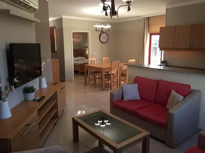 a living room with a red couch and a table at Cozy Apartment with Red Sea View in Hurghada