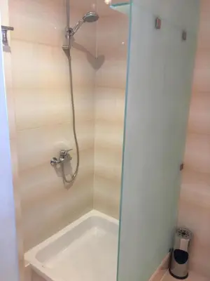 a bath tub with a shower in a bathroom at Cozy Apartment with Red Sea View in Hurghada