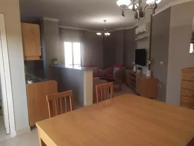 a kitchen and living room with a table and chairs at Cozy Apartment with Red Sea View in Hurghada