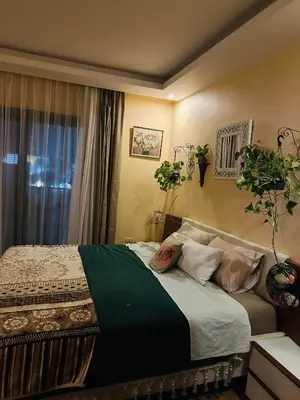 a bedroom with a bed with pillows and a window at شاليه في ستيلا مكادي الغردقة in Hurghada