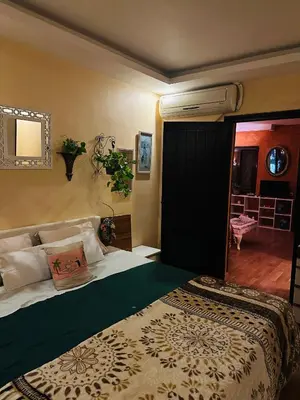 a bedroom with a bed and a room with a hallway at شاليه في ستيلا مكادي الغردقة in Hurghada