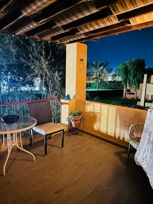 a patio with a table and chairs on a balcony at شاليه في ستيلا مكادي الغردقة in Hurghada