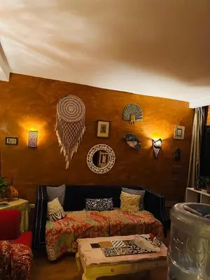 a living room with a bed and a table at شاليه في ستيلا مكادي الغردقة in Hurghada