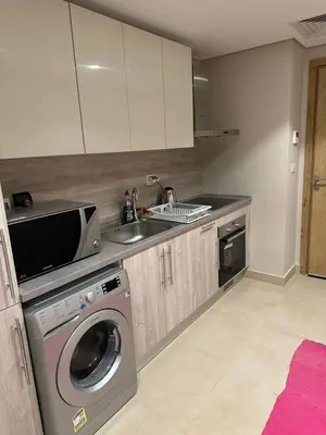 a kitchen with a washing machine and a sink at Pool & Sea View 2BR in Mangroovy in Hurghada