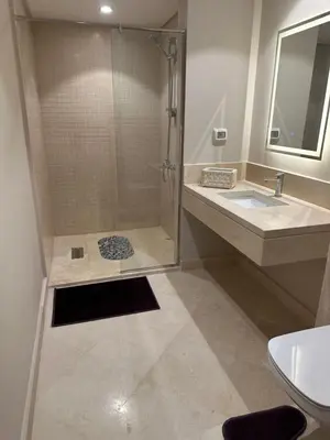 a bathroom with a shower and a sink at Pool & Sea View 2BR in Mangroovy in Hurghada
