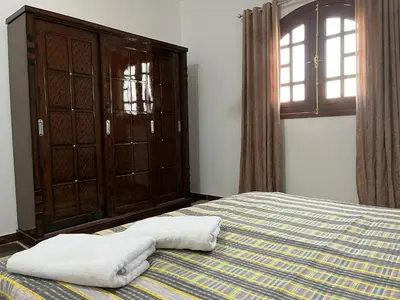 a bedroom with a bed with two towels on it at Habiba Apartment in Luxor