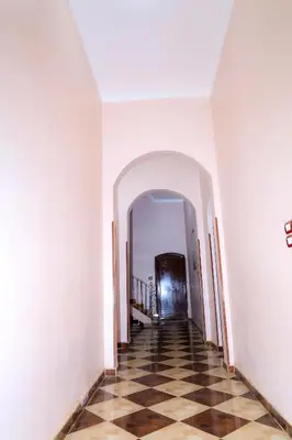 an empty hallway with a checkered floor in a building at Habiba Apartment in Luxor
