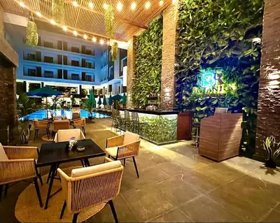 a restaurant with tables and chairs and a building at Studio pool view at Imperial Resort Hurghada in Hurghada