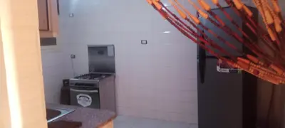 a small kitchen with a stove and a refrigerator at Nile palace in Jazīrat Aswān