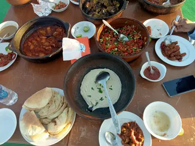 a table with many different dishes of food on it at Shalal Farm and guest house in Aswan