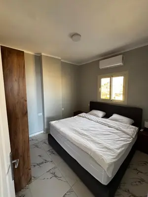 a bedroom with a bed and a window at Seaside Serenity Apartment in Hurghada
