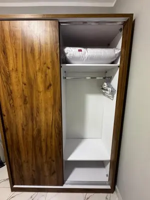 a small white refrigerator in a room at Seaside Serenity Apartment in Hurghada