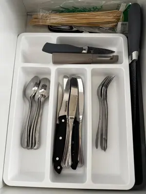 a white tray with utensils in a drawer at Seaside Serenity Apartment in Hurghada