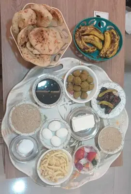 a table with different types of food on it at Gannet Alyousef City Center in Naj‘ al Maḩaţţah