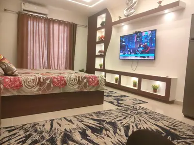 a bedroom with a bed and a tv on a wall at Tiba Golden a in Hurghada