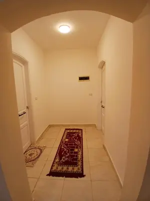 a hallway with a rug on the floor next to a door at Nopian 1 in Luxor