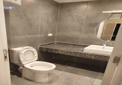 a bathroom with a toilet and a sink and a mirror at Private 2BR Apartment with Private Heated Pool at Bali D3 in Hurghada