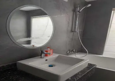 a bathroom with a sink and a mirror and a tub at Private 2BR Apartment with Private Heated Pool at Bali D3 in Hurghada
