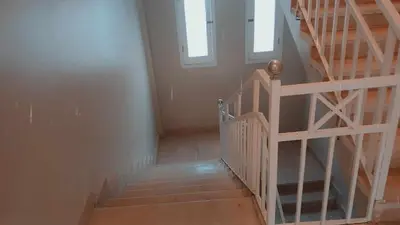 a staircase in a house with two windows at Valencia Villa & Rooms in Luxor