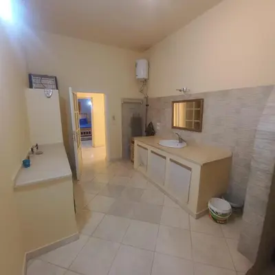 a large bathroom with a sink and a mirror at El Fayrouz Villa in Luxor