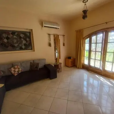 a living room with a couch and a large window at El Fayrouz Villa in Luxor