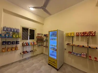 a room with a refrigerator and shelves of food at Holiday Dream Of Luxor in Luxor