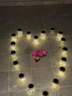 a table with candles and a bouquet of flowers and lights at Holiday Dream Of Luxor in Luxor