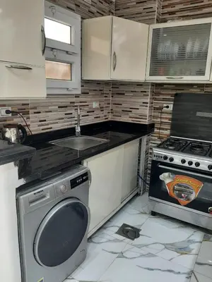 a kitchen with a stove and a sink and a dishwasher at شقه سوبر لوكس in Hurghada