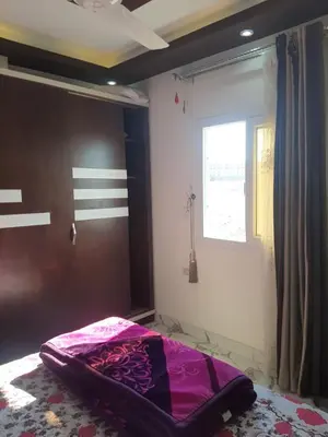 a bed in a room with a window at شقه سوبر لوكس in Hurghada