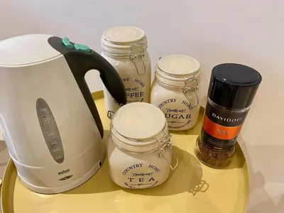 a counter with a tea kettle and jars of honey at 2BR Mangroovy Ground floor in Hurghada