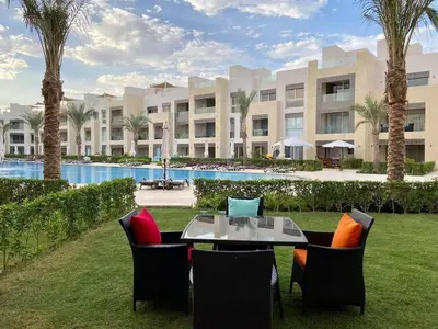 a patio with a table and chairs in front of a building at 2BR Mangroovy Ground floor in Hurghada