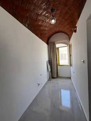 a hallway with a brick ceiling and a window at Sunrise Apartment in Hurghada