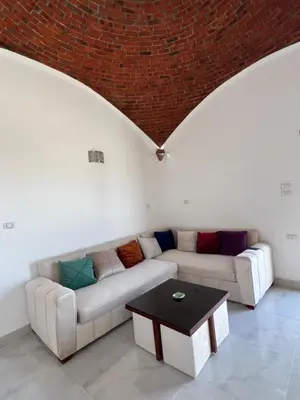 a living room with a couch and a table at Sunrise Apartment in Hurghada