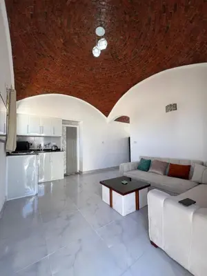 a living room with a couch and a table at Sunrise Apartment in Hurghada