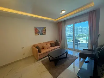 a living room with a couch and a table at Cozy one bedroom in a compound with beach ac in Hurghada