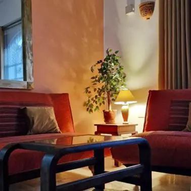 a living room with a couch and a table with a plant at Hurghada mit Charme in Hurghada