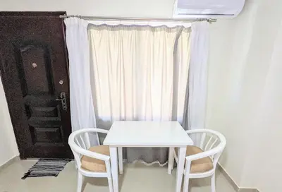 a white table and two chairs in front of a window at Fanta Sea Studio with private jacuzzi - Al Ahyaa in Hurghada