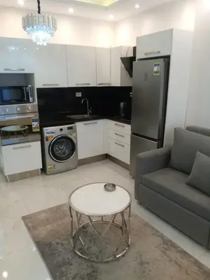a kitchen with a couch and a table in a room at الغردقه in Hurghada