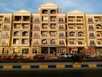 a large building with cars parked in front of it at الغردقه in Hurghada