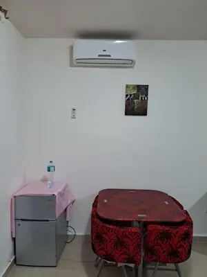 a room with a table and a suitcase at Studio in elkarma resort & aqua park in Hurghada