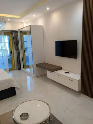 a living room with a tv on a wall at Hurghadiansrealty in Hurghada
