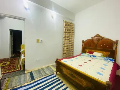 a bedroom with a bed in a room at Pharaoh apartment 2 in Luxor