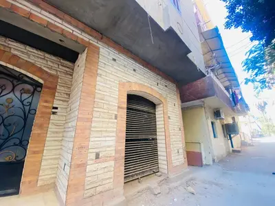 a building with a garage door on the side of it at Pharaoh apartment 2 in Luxor